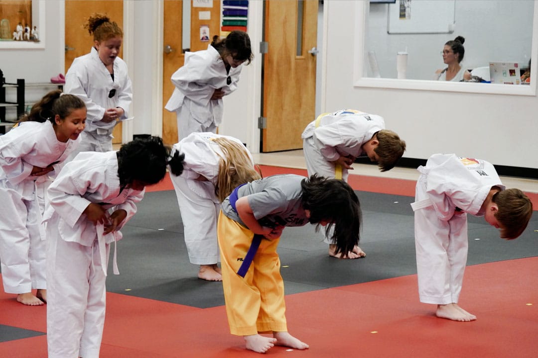 Why Martial Arts Teach Discipline and Respect for Kids Ages 7–12 Kids martial arts class ages 7–12 bowing together to practice discipline, respect, and self-control in Peachtree City